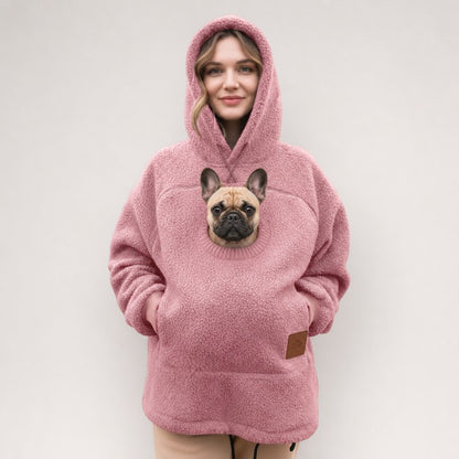 Pink Sherpa French Bulldog Carrier Hoodie on a model with a Frenchie peeking out of the pouch