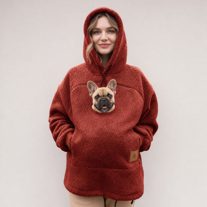 Red Sherpa French Bulldog Carrier Hoodie on a model with a Frenchie peeking out of the pouch